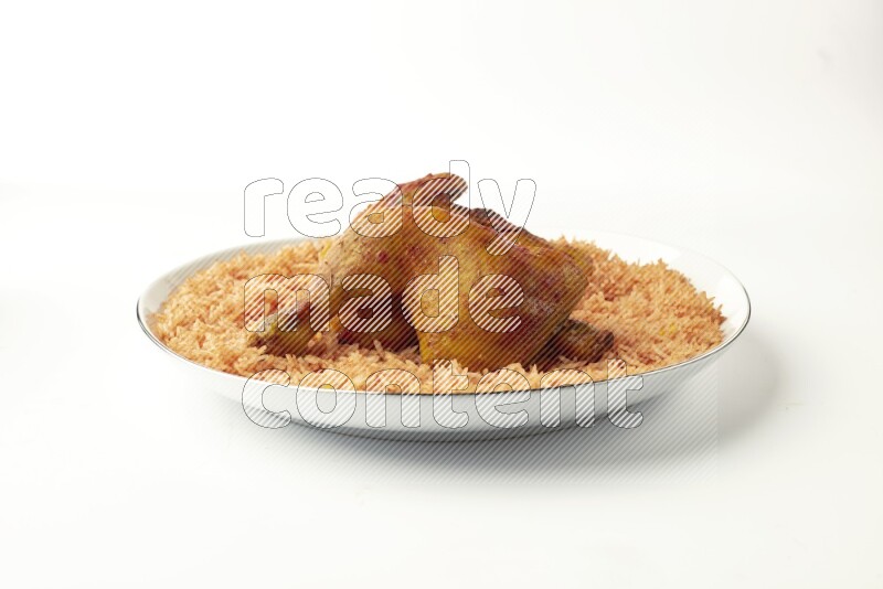 red basmati Rice with  kabsa chicken pieces on a white plate with a silver rim direct  on white background