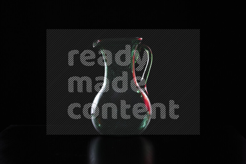 Glassware with rim light in red and white against black background