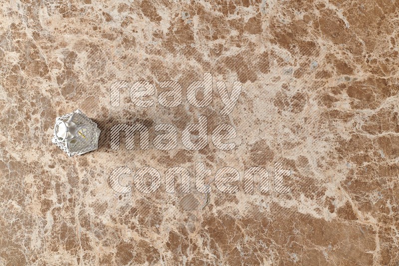Top View Shot Of Candle Lantern On beige Marble Flooring