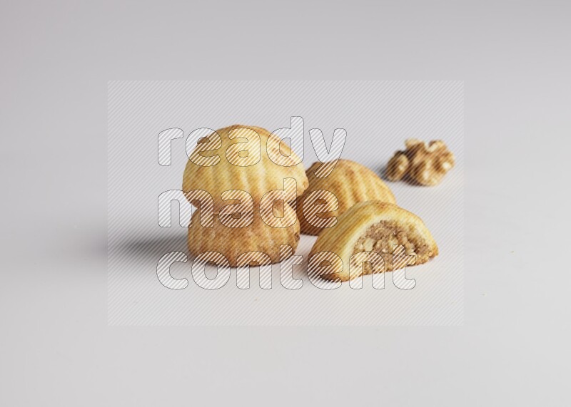 Four Pieces of Maamoul filled with walnut paste  one of them is cut direct on white background