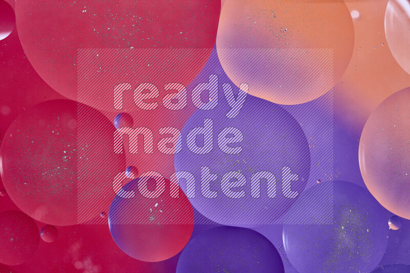 لقطات مقربة لفقاعات من الزيت على سطح الماء باللون الأحمر والبرتقالي والأرجواني