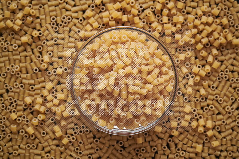 Small rings pasta in a glass bowl on black background