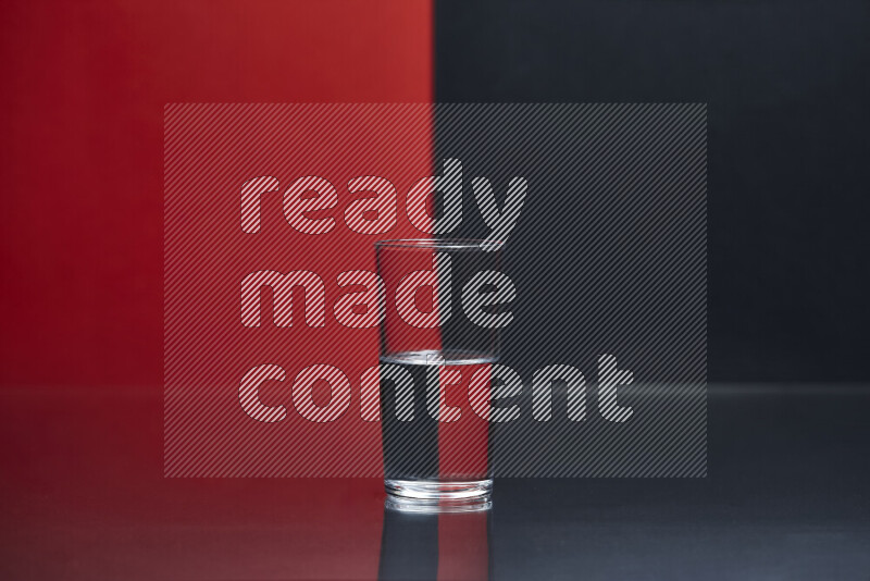 The image features a clear glassware filled with water, set against red and black background