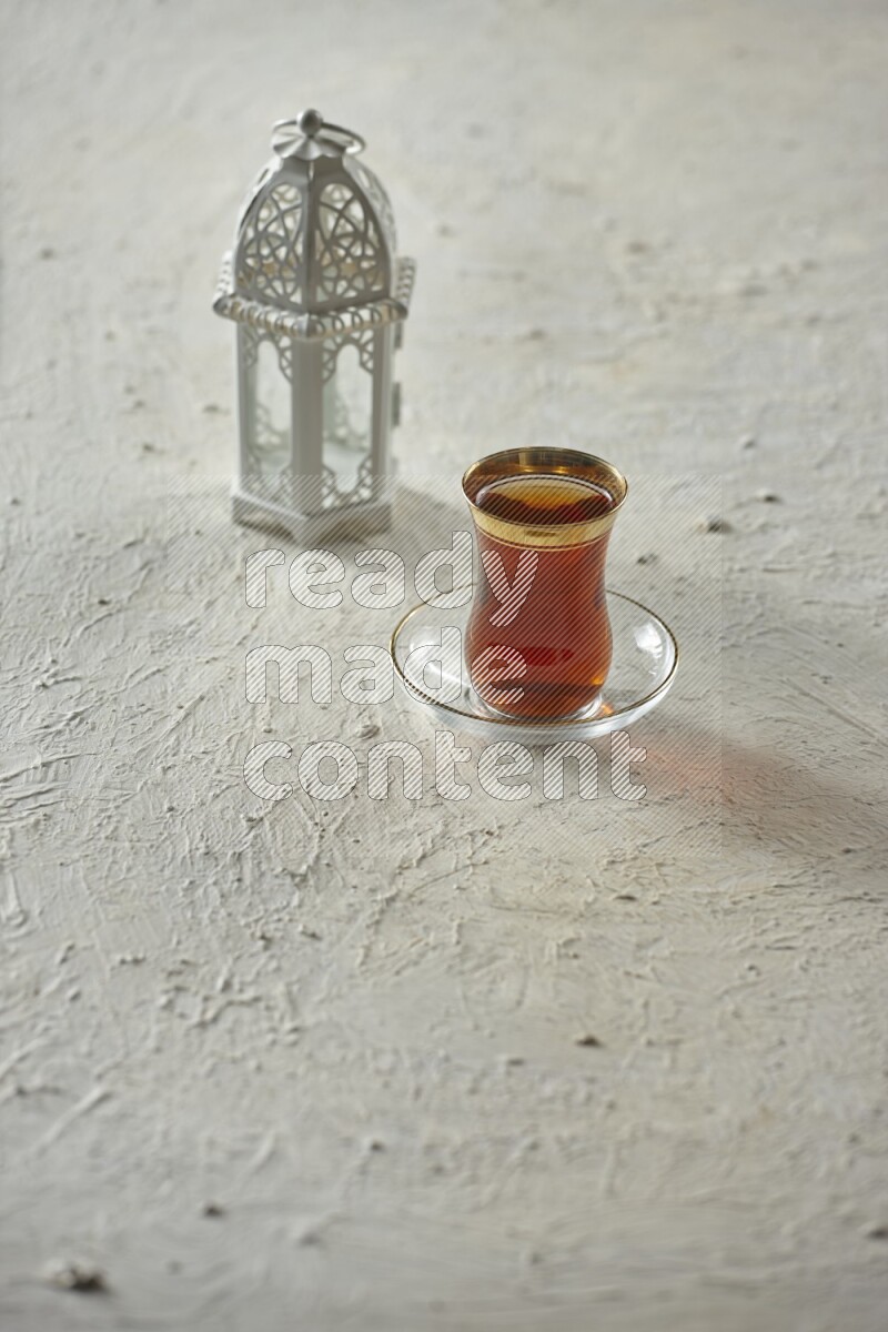 A white lantern with different drinks, dates, nuts, prayer beads and quran on white background