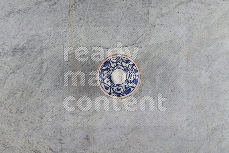 Top View Shot Of A Multicolored Pottery Pot On Grey Marble Flooring