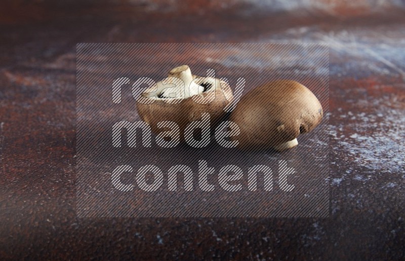 45 degre cremini  mushrooms on a textured reddish rustic metal background