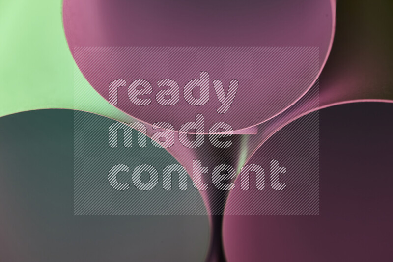 The image shows an abstract paper art with circular shapes in varying shades of green and purple