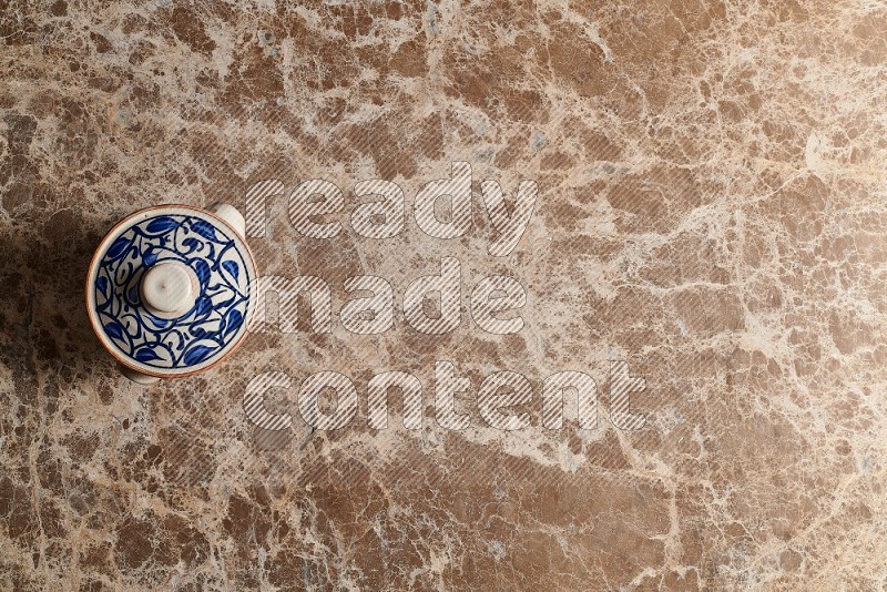 Top View Shot Of A Multicolored Pottery pot On beige Marble Flooring