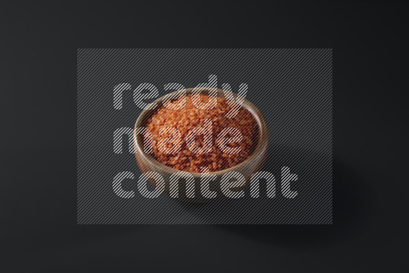 Lentils in a wooden bowl on grey background