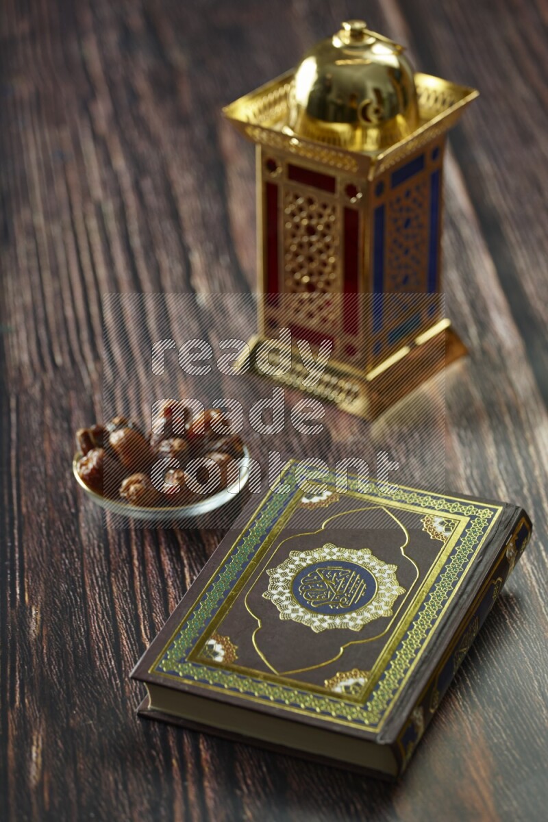 A golden lantern with different drinks, dates, nuts, prayer beads and quran on brown wooden background