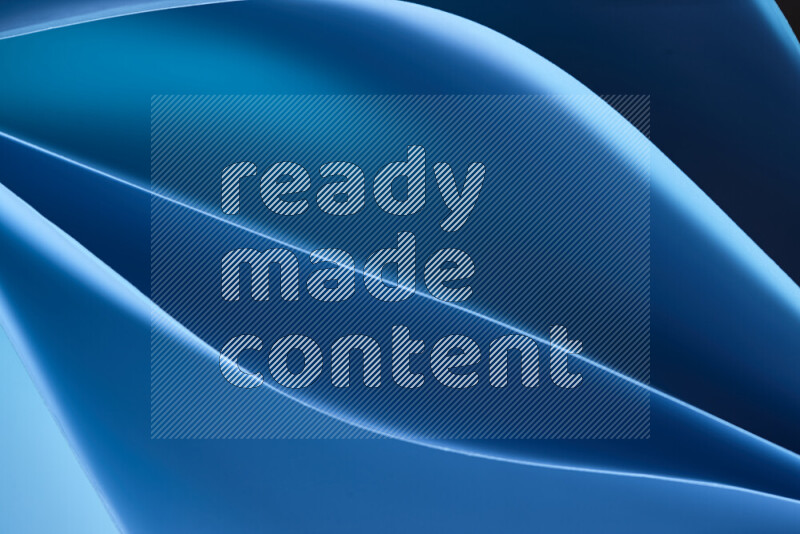 This image showcases an abstract paper art composition with paper curves in blue gradients created by colored light