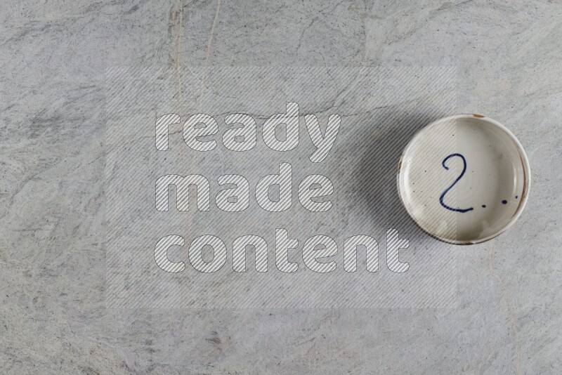 A multicolored pottery Bowl on grey marble background