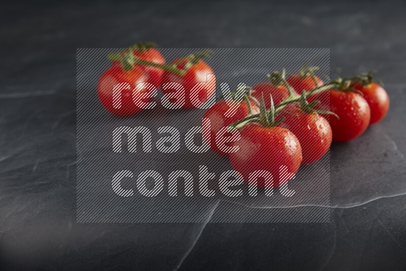 Red cherry tomato vein on a textured black slate background 45 degree