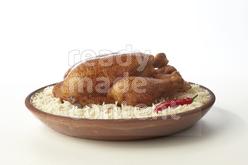 white  basmati Rice with  whole roasted chicken    on a pottery plate  direct  on white background