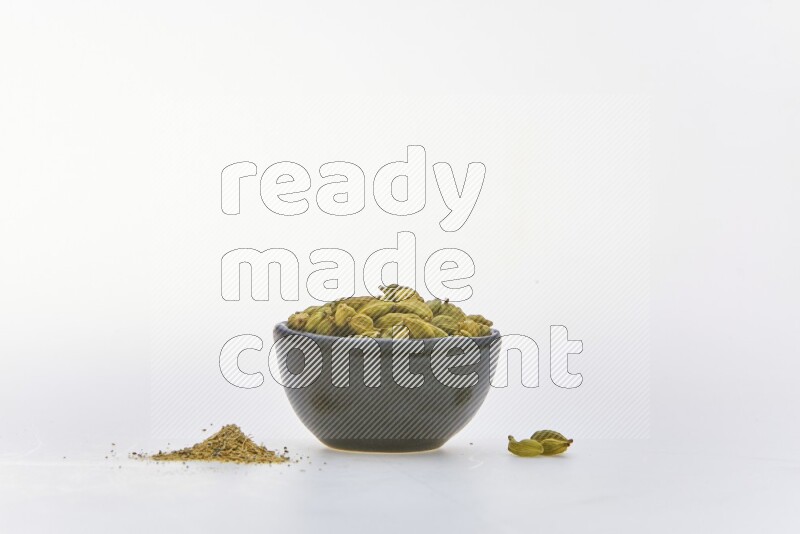 Cardamon in a container on white background