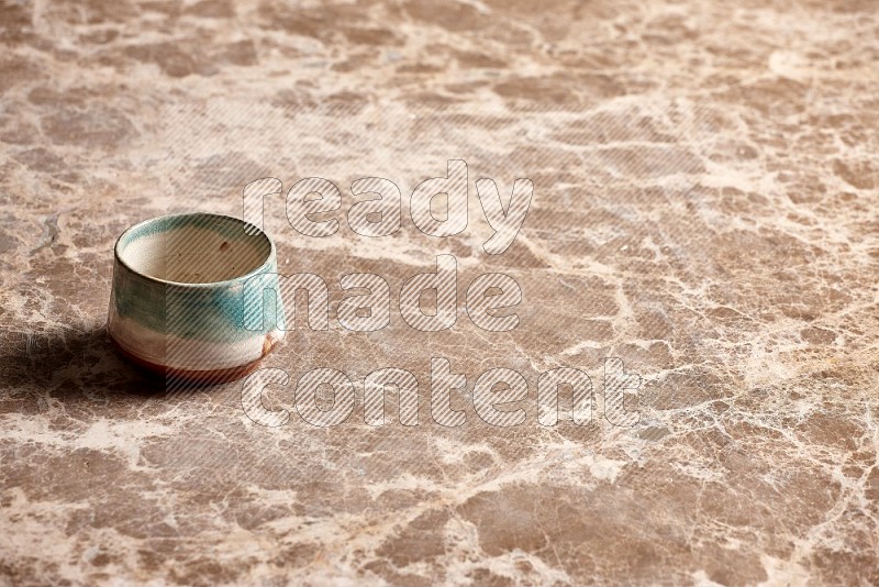 Multicolored Pottery Bowl on Beige Marble Flooring