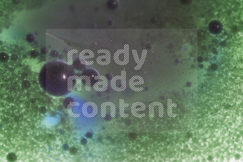 Close-ups of abstract green and blue watercolor drops on oil Surface on white background