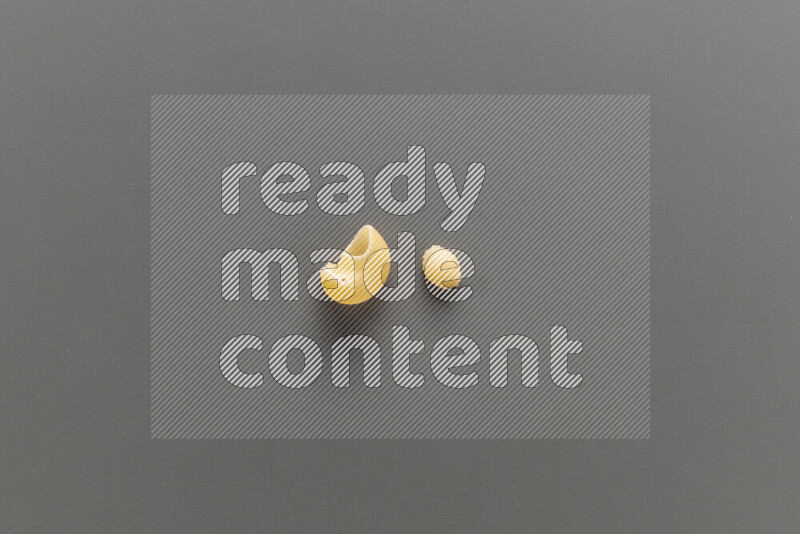 Pipe pasta with other types of pasta on grey background