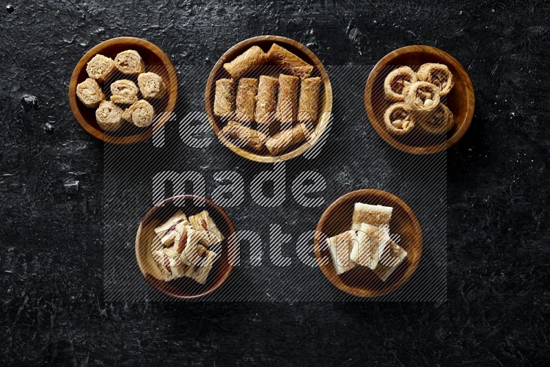 Oriental sweets in wooden bowls in a dark setup