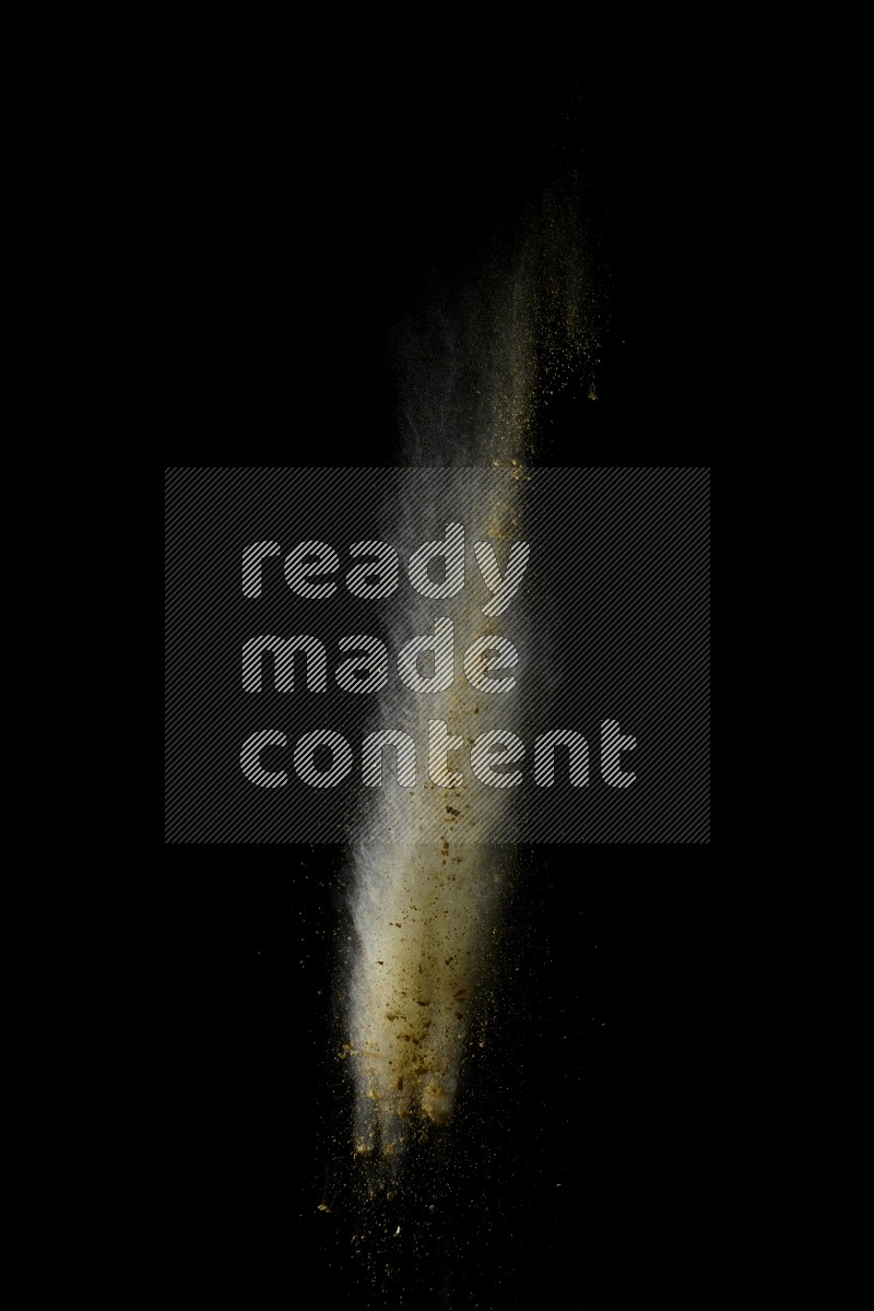 A side view of yellow powder explosion on black background