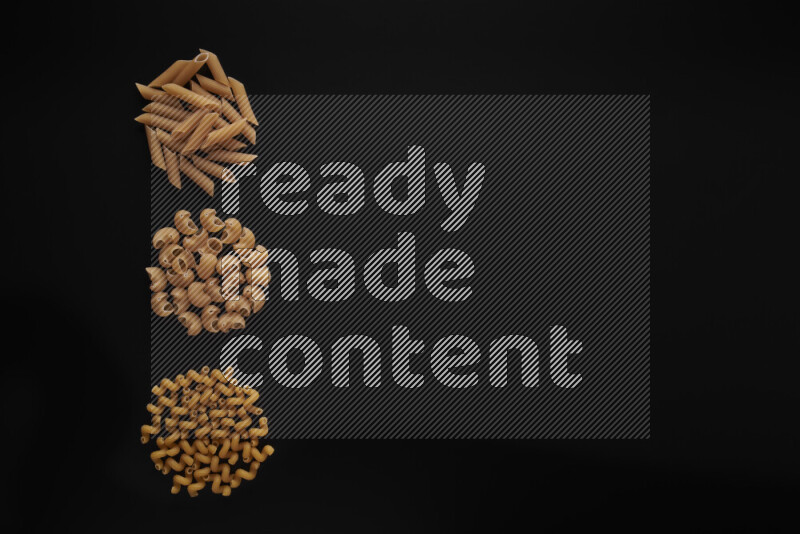 Different pasta types in 3 bunches on black background