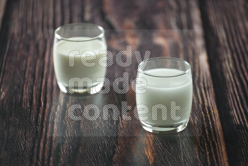 Cold drinks in a glass cup such as water, tamarind, qamar eldin, sobia, milk and hibiscus on wooden background