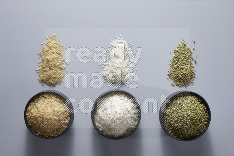 Legumes in pottery bowls on light grey background