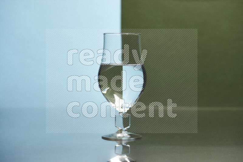 The image features a clear glassware filled with water, set against light blue and dark green background