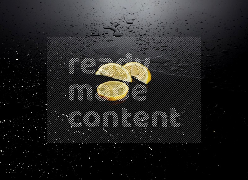 Lemon slices with water drops, and droplets on black background