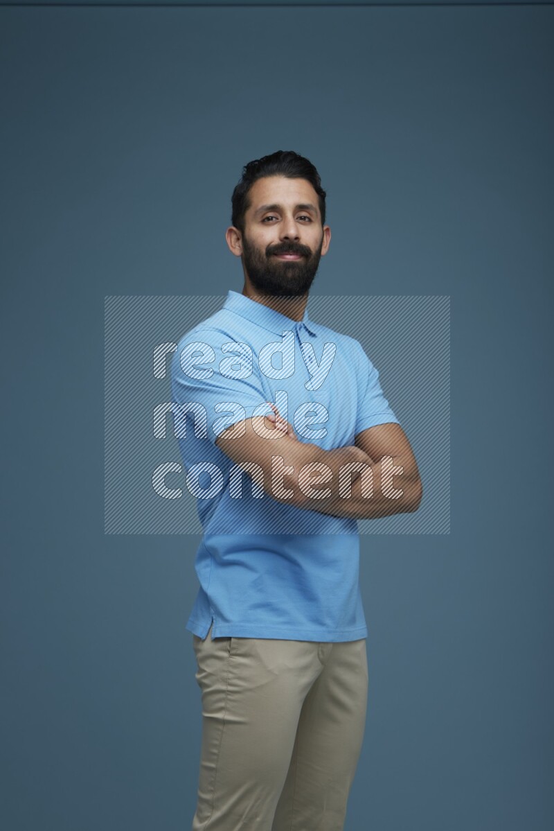 Man posing in a blue background wearing a Blue shirt