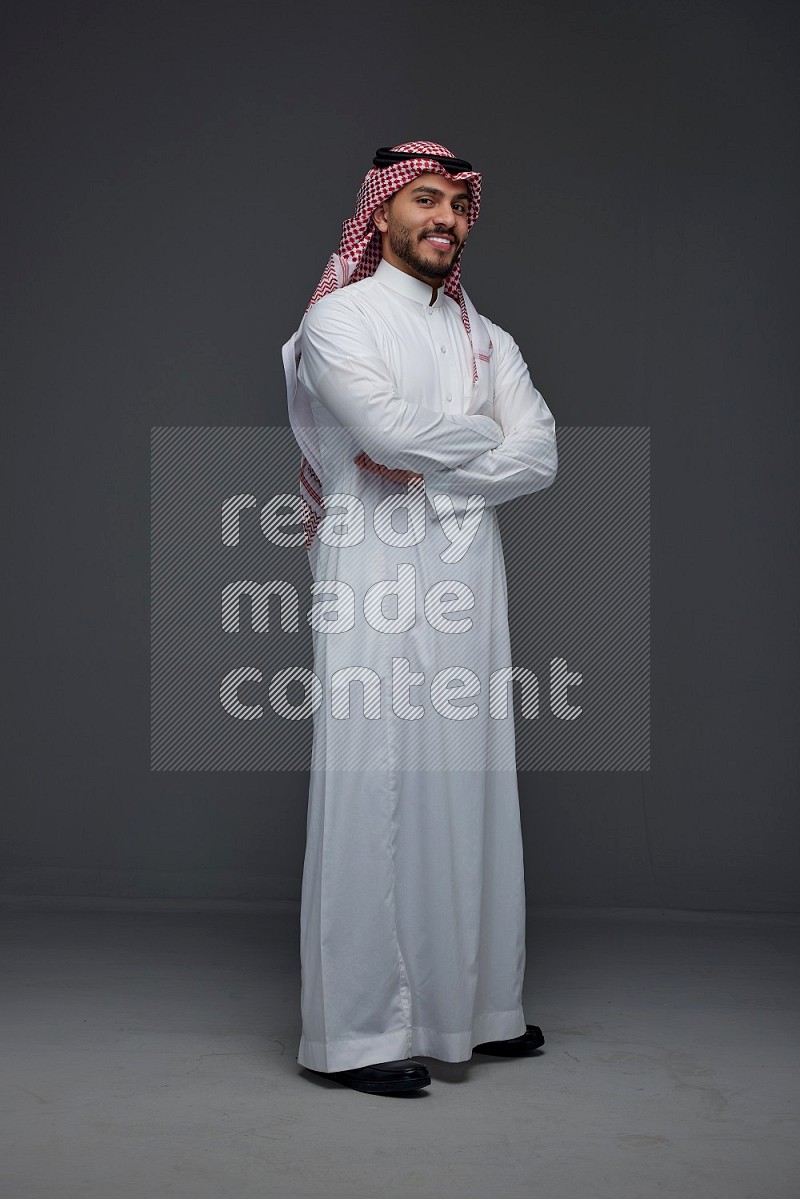 A Saudi man wearing Thobe and Shmagh standing in different poses eye level on a gray background