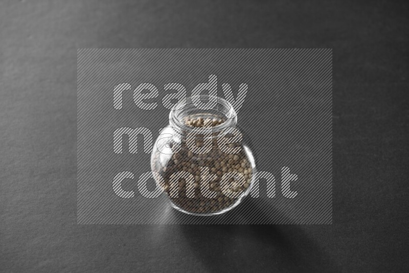 فلفل أبيض في وعاء زجاجي علي خلفية سوداء