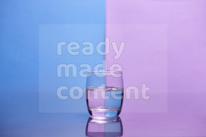 The image features a clear glassware filled with water, set against blue and light purple background