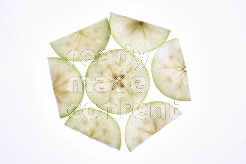 Apple slices on illuminated white background