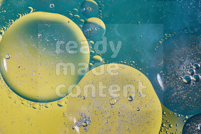 Close-ups of abstract oil bubbles on water surface in shades of green and yellow