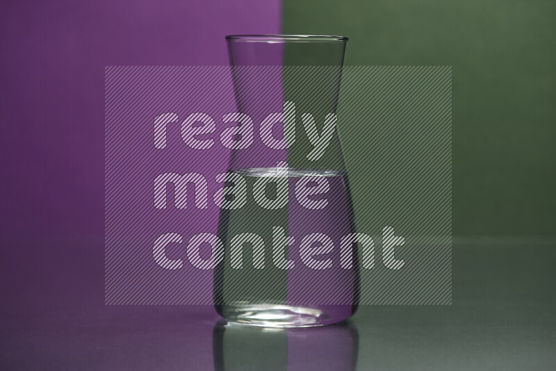 The image features a clear glassware filled with water, set against purple and dark green background