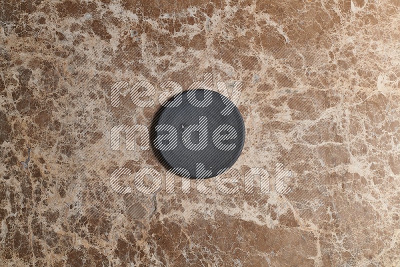 Top View Shot Of A Pottery Coaster On beige Marble Flooring
