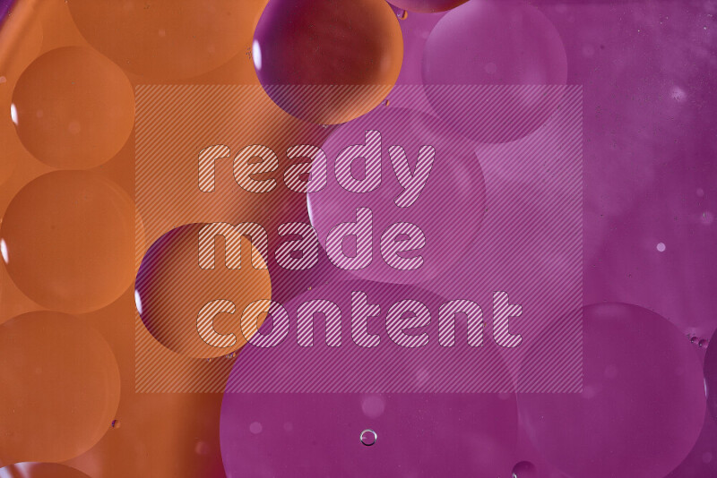 لقطات مقربة لفقاعات من الزيت على سطح الماء باللون البرتقالي والوردي