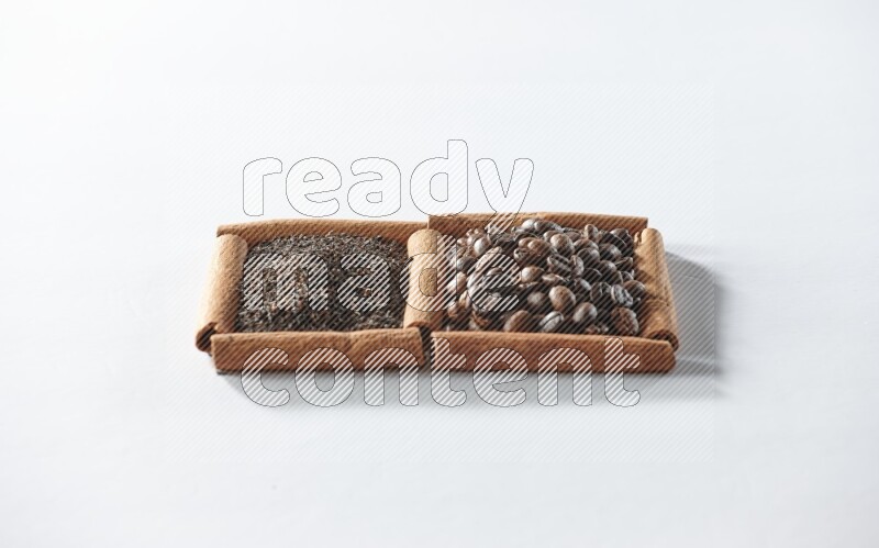 2 squares of cinnamon sticks full of coffee beans and black tea on white flooring