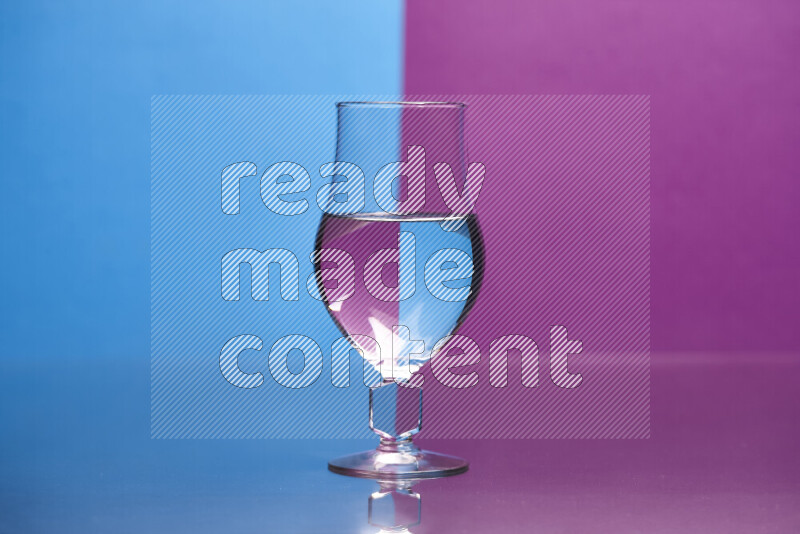 The image features a clear glassware filled with water, set against blue and purple background