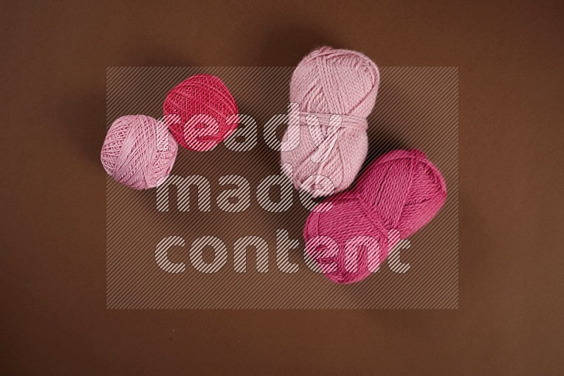 Pink sewing supplies on brown background