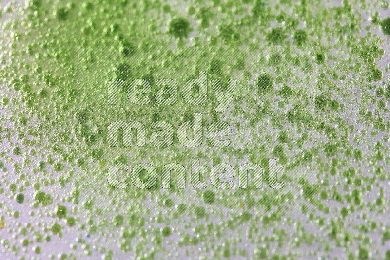 Close-ups of abstract green watercolor drops on oil Surface on white background