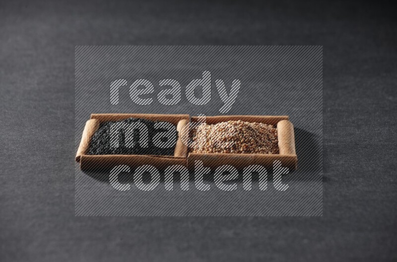 2 squares of cinnamon sticks full of mustard seeds and black seeds on black flooring