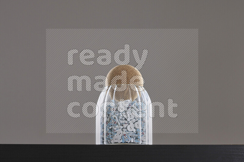 Buttons in a glass jar on black background