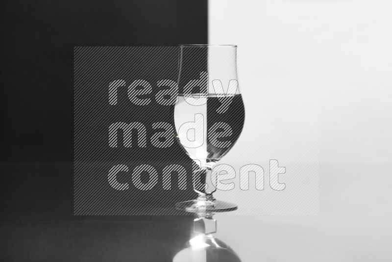 The image features a clear glassware filled with water, set against white and black background