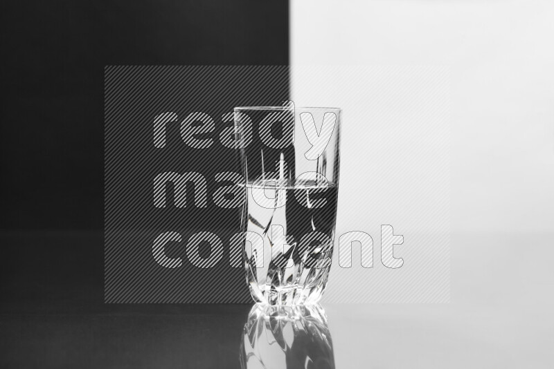 The image features a clear glassware filled with water, set against white and black background