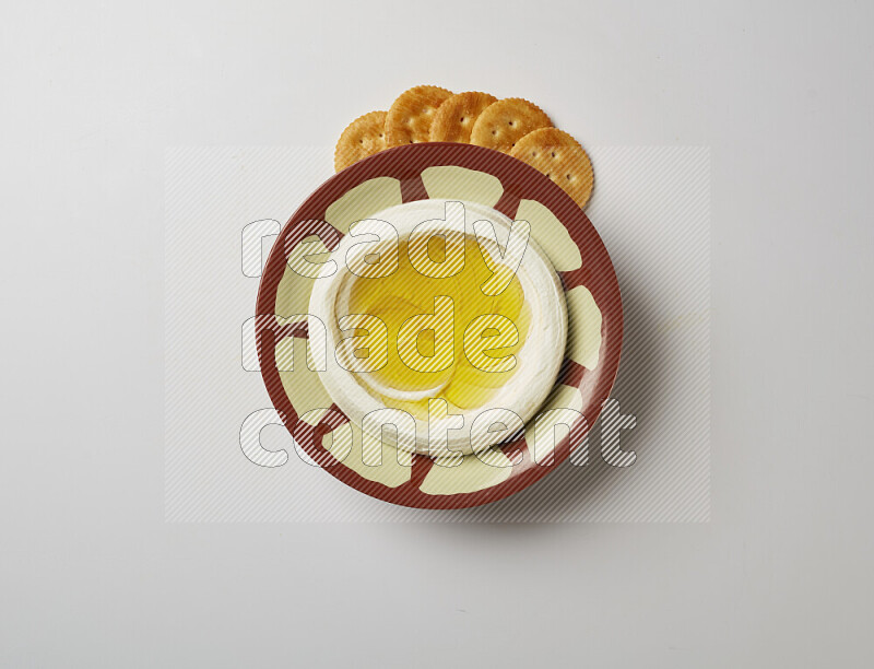 Lebnah garnished with olive oil in a traditional plate on a white background