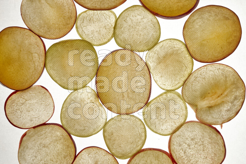 Plum slices on illuminated white background