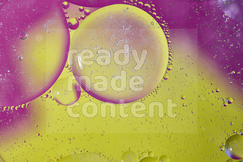 Close-ups of abstract oil bubbles on water surface in shades of yellow and pink