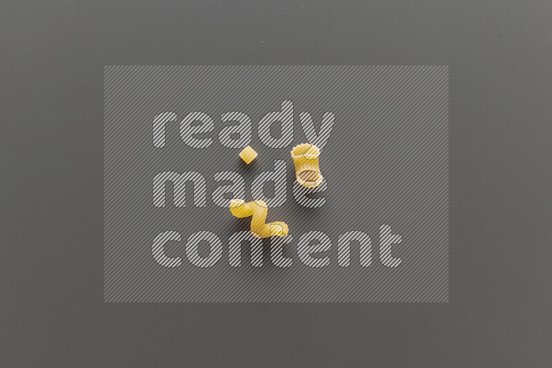 Different pasta types on grey background